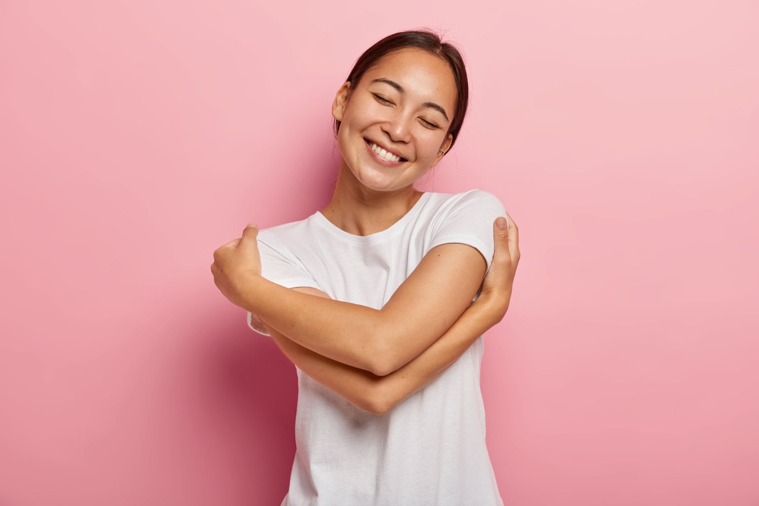 a girl hugs herself