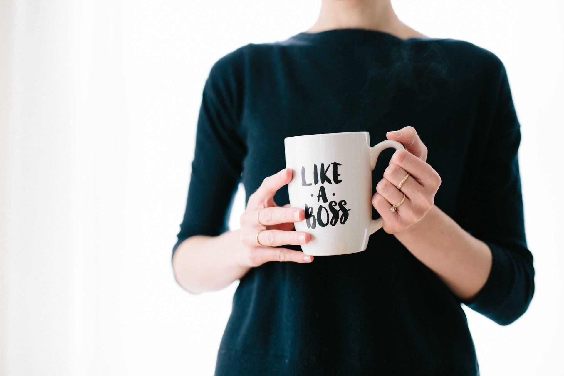 powerful women with mug that says like a boss