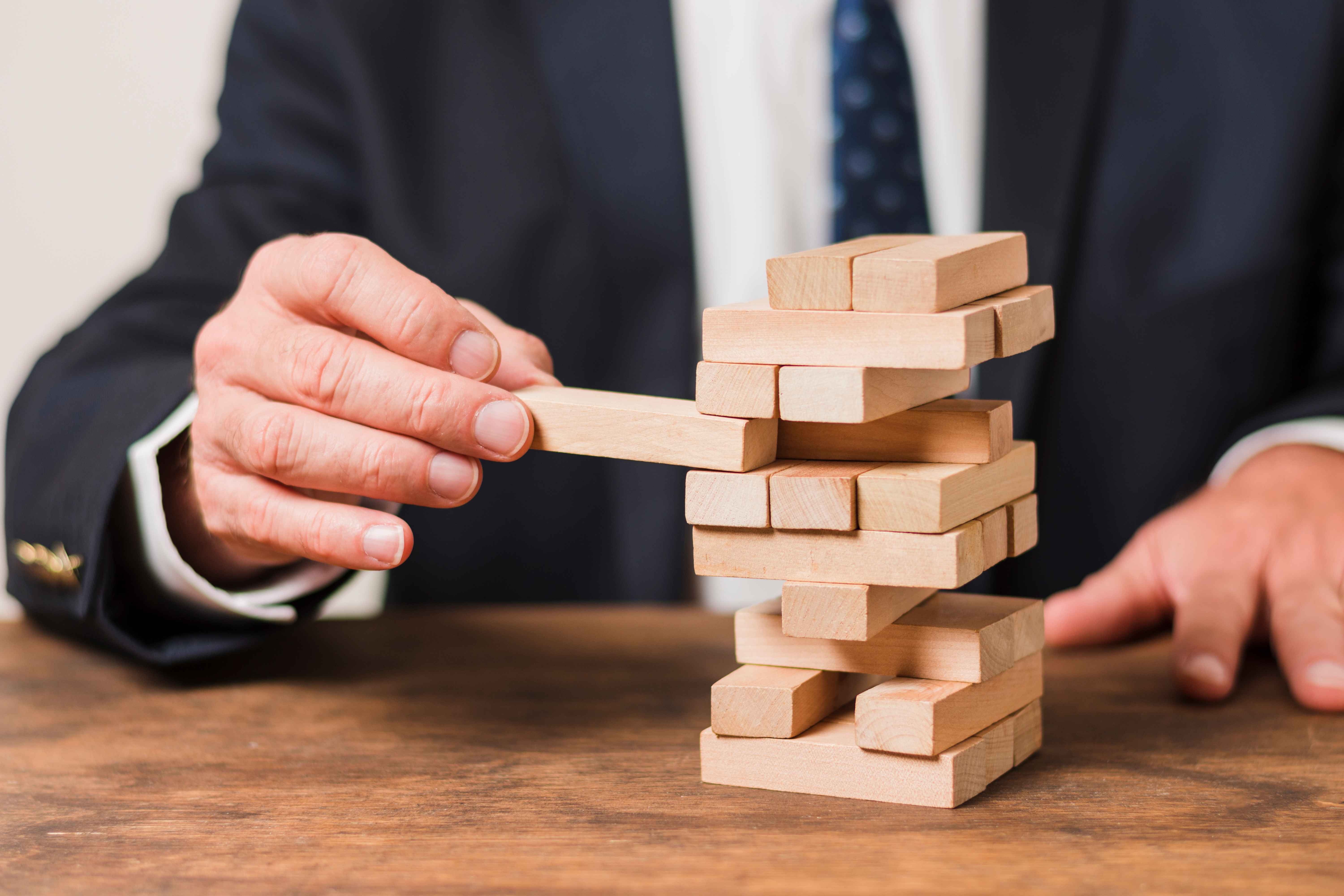 businessman playing jenga