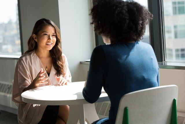 Two women having a conversation at work