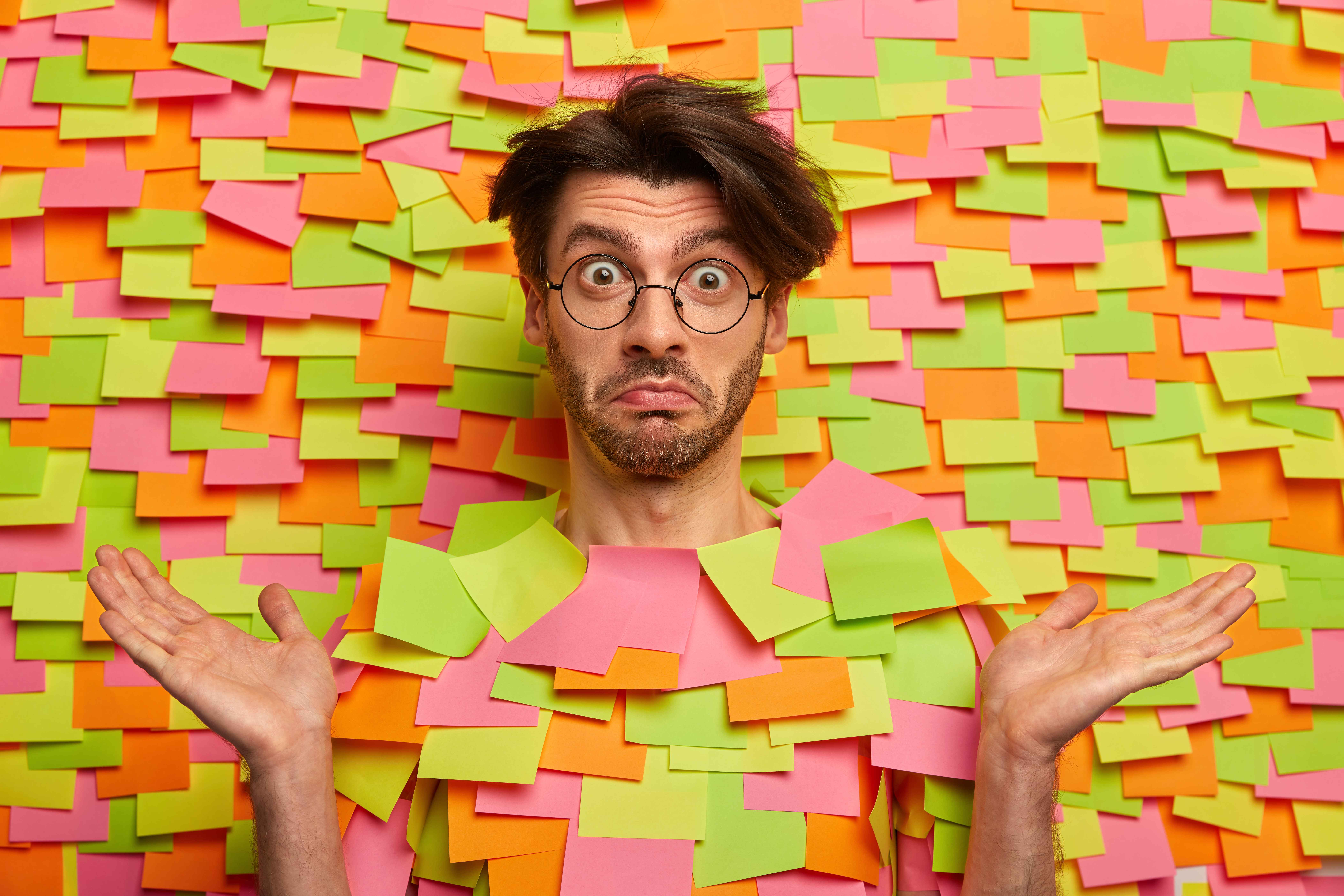 man drowning in sticky notes