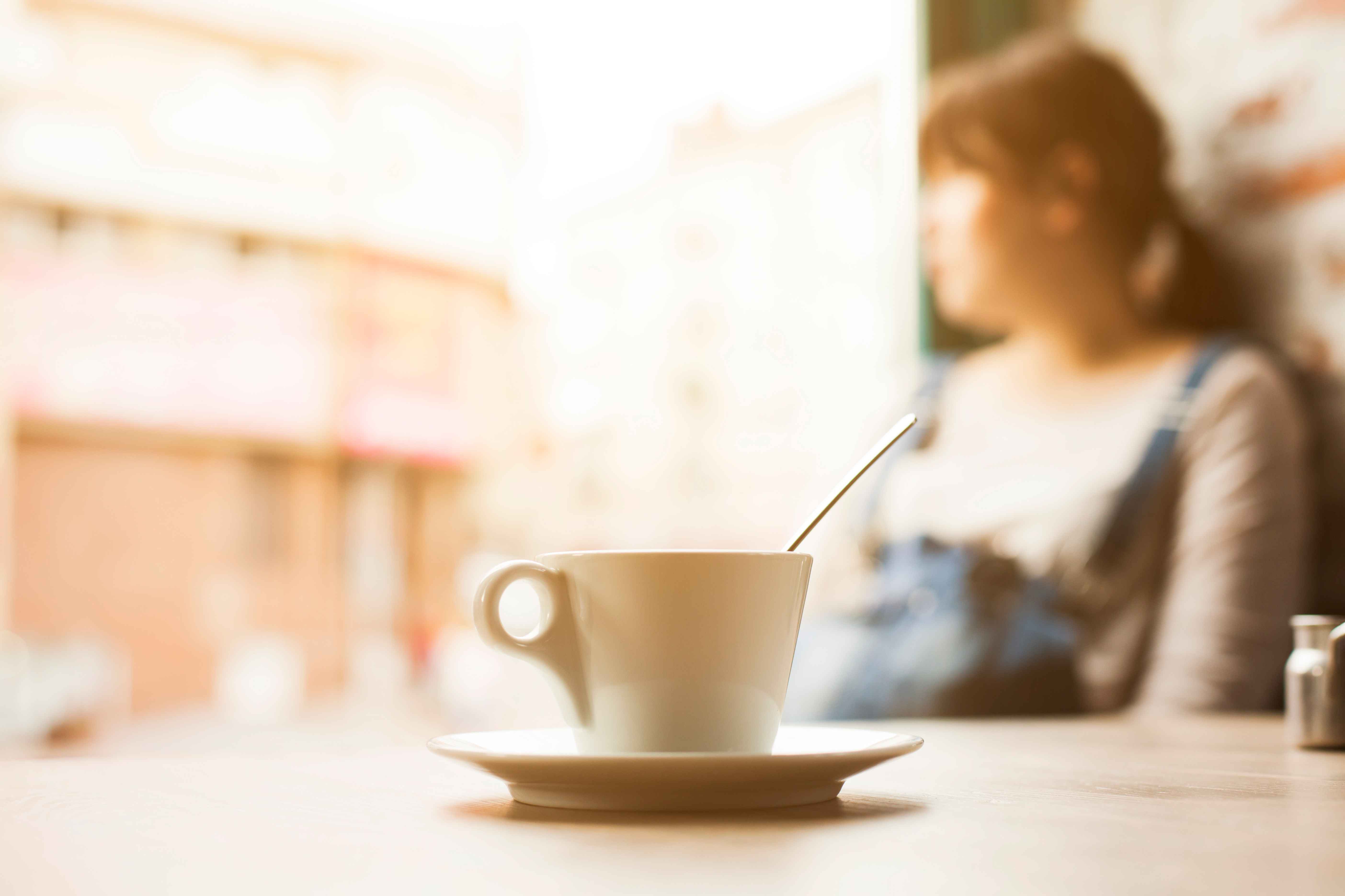 woman by the window drinking coffee