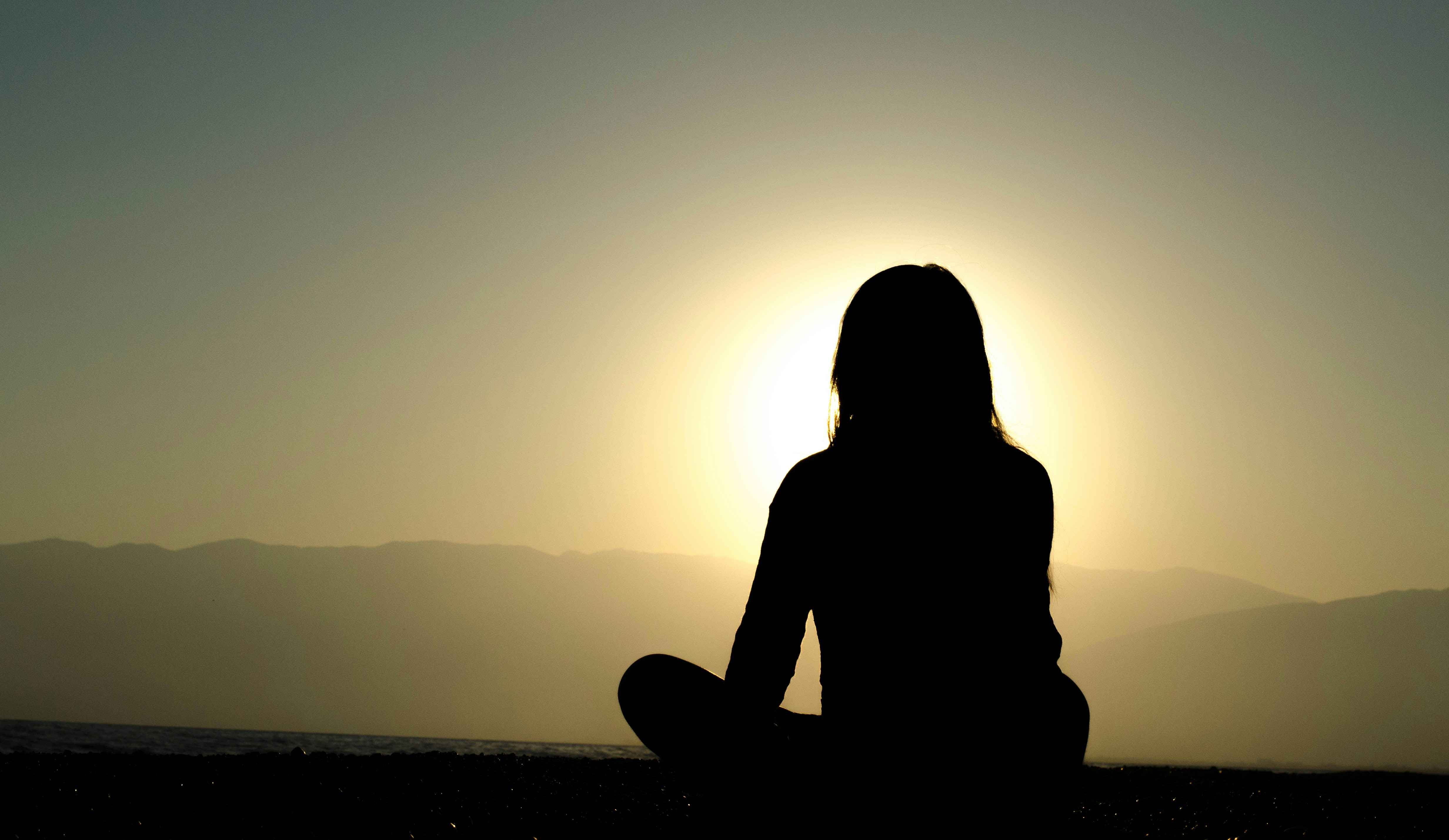young woman meditating early in the morning