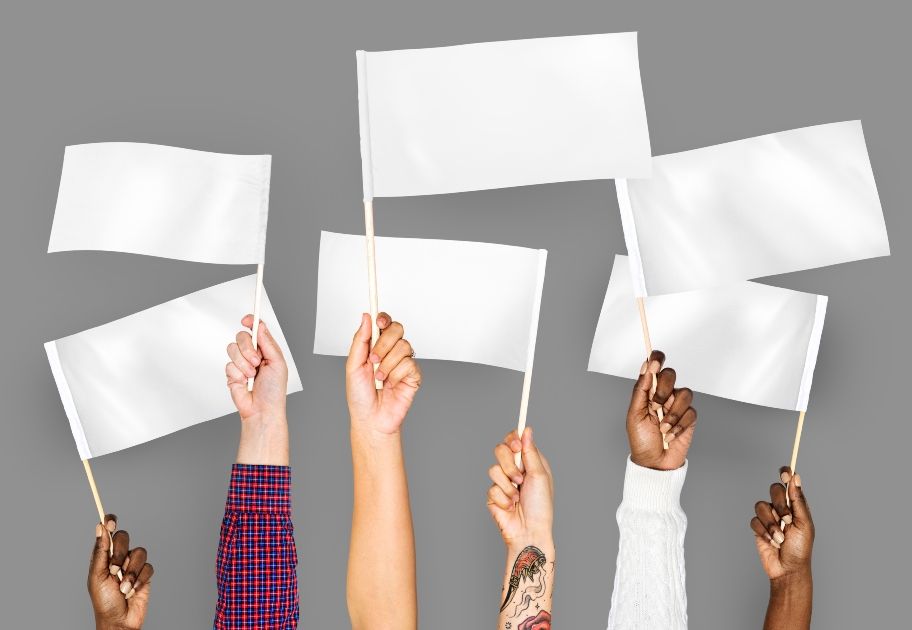 hands waving white flags signifying quiet quitting