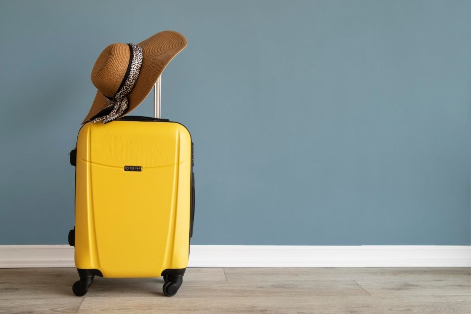 a travel bag and beach hat ready for the holidays