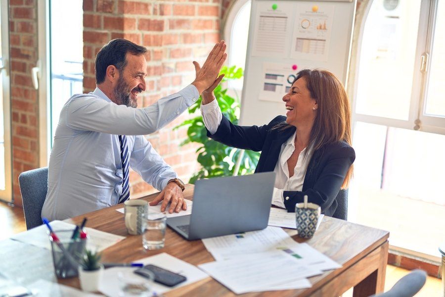 Two people sharing a high 5 (engage)