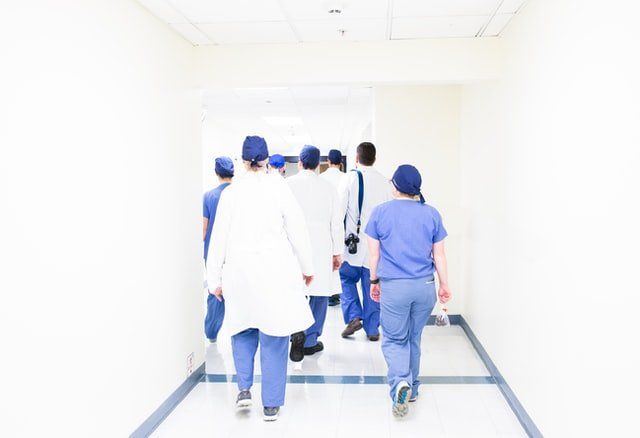 group of doctors walking on the hospital hallway