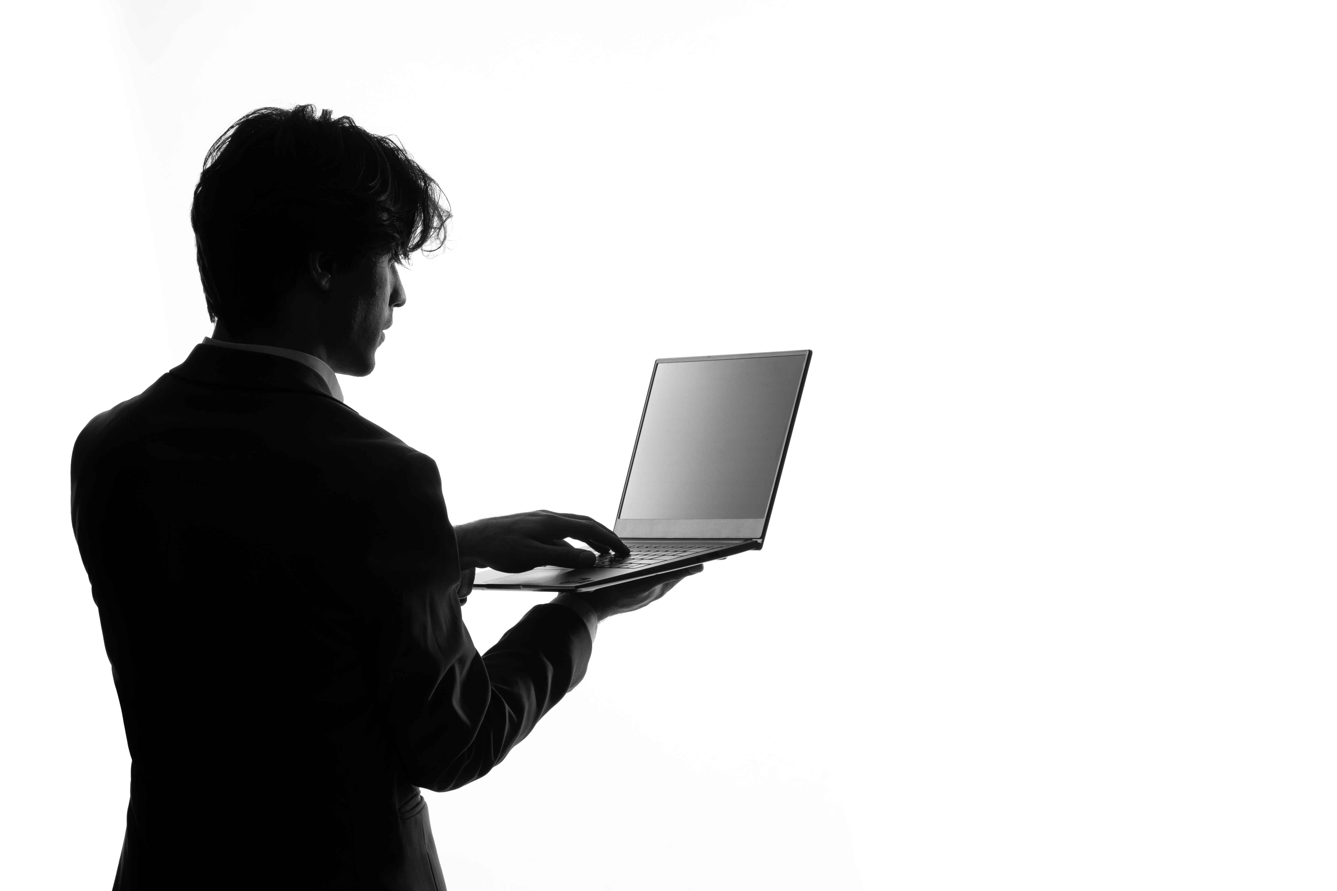man holding a laptop silhouette