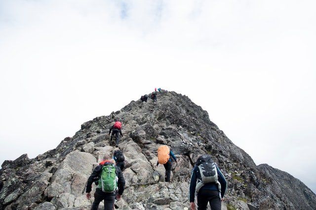 leadership: mountain climbers with a leader at the helm of the group