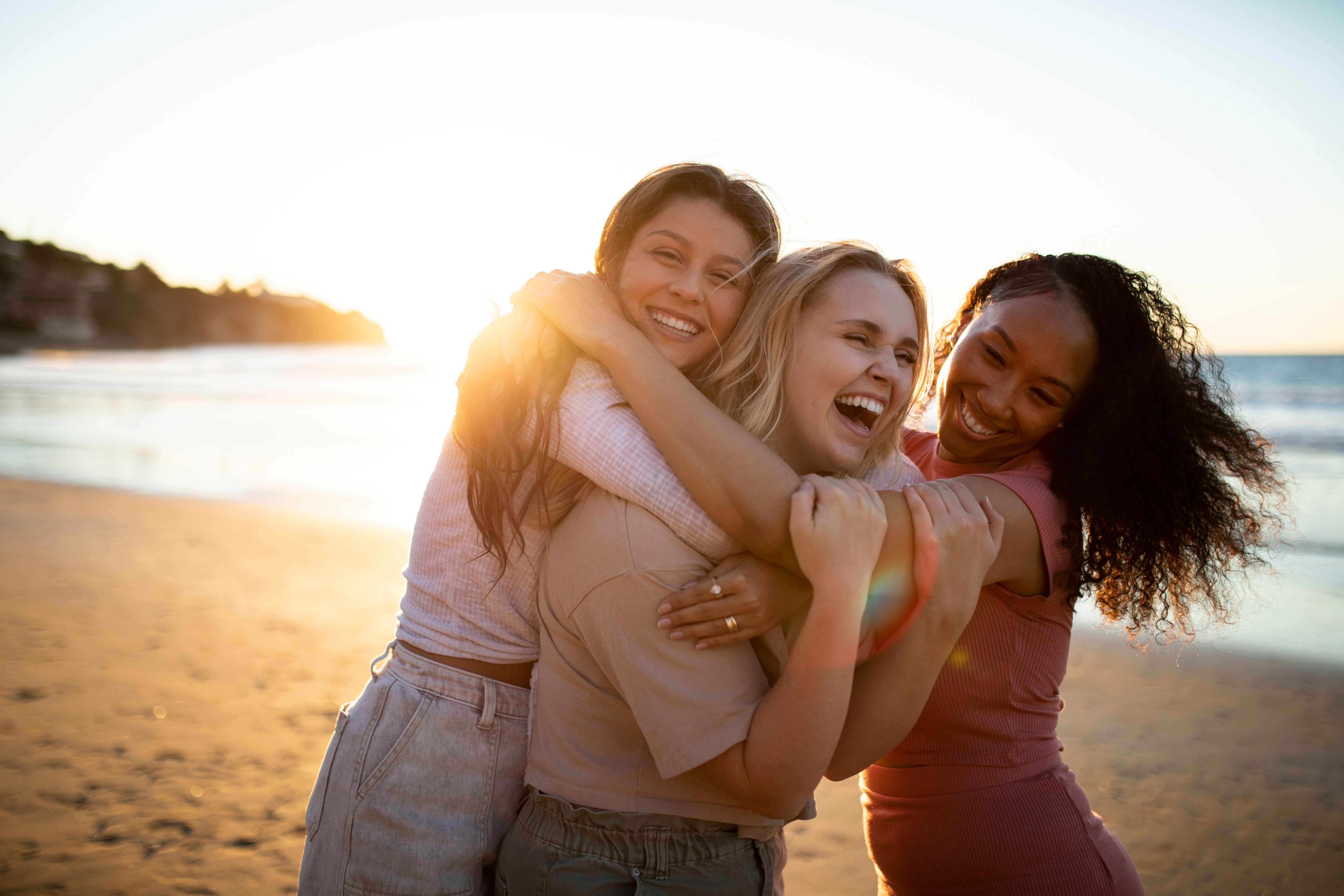 smiley women hugging