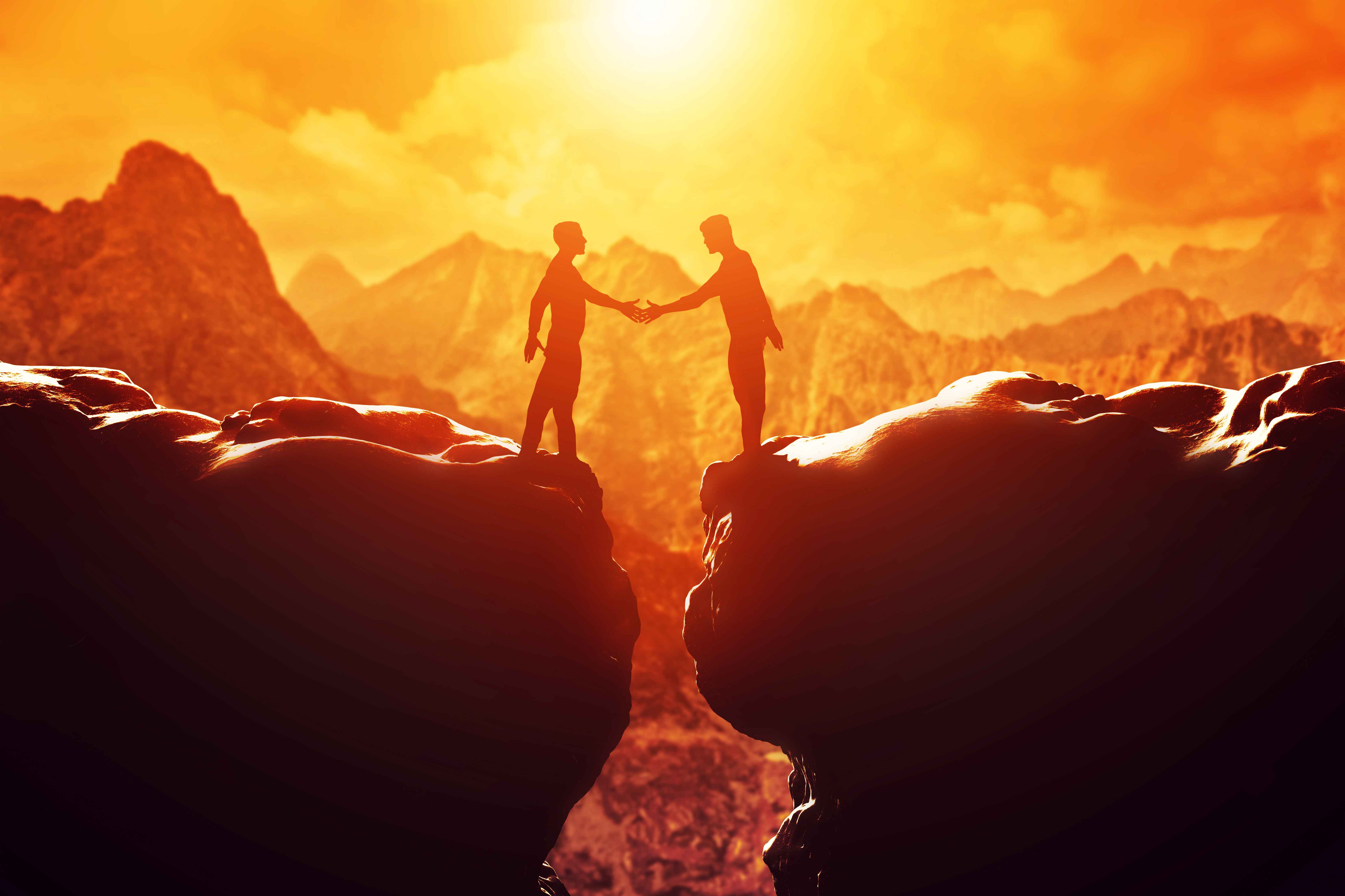 silhouette of two people giving handshake