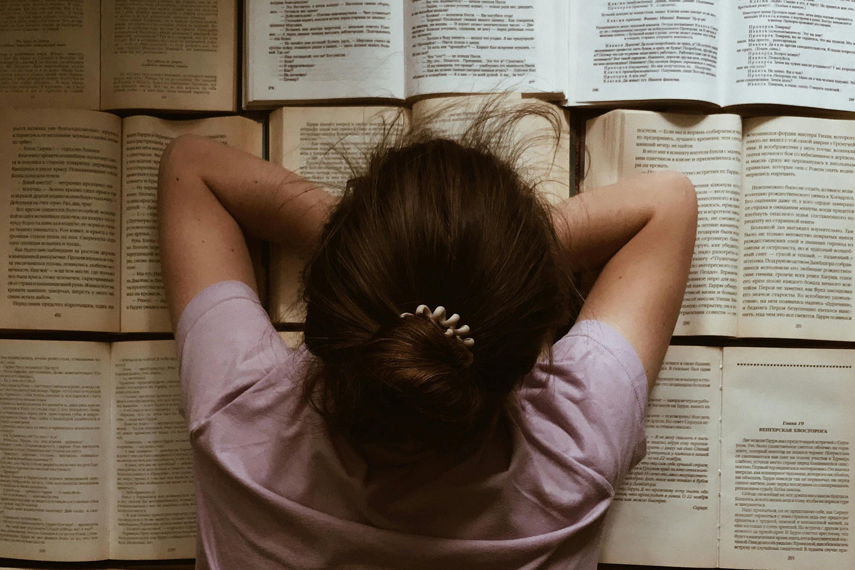 Woman Lying on Open Books