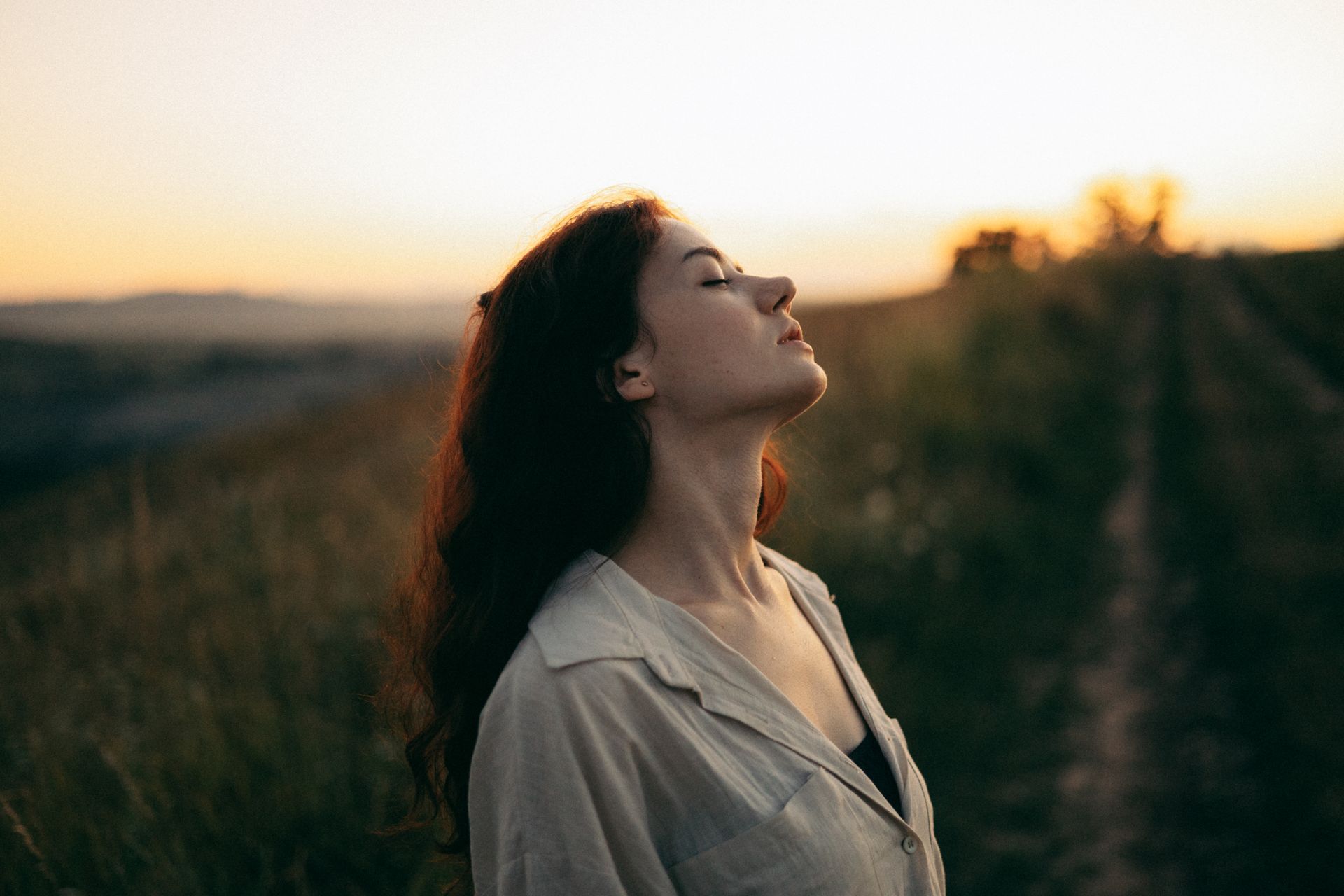 Woman standing with eyes closed