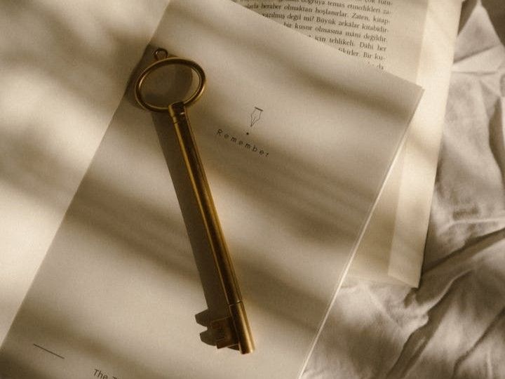 a vintage key on an open book