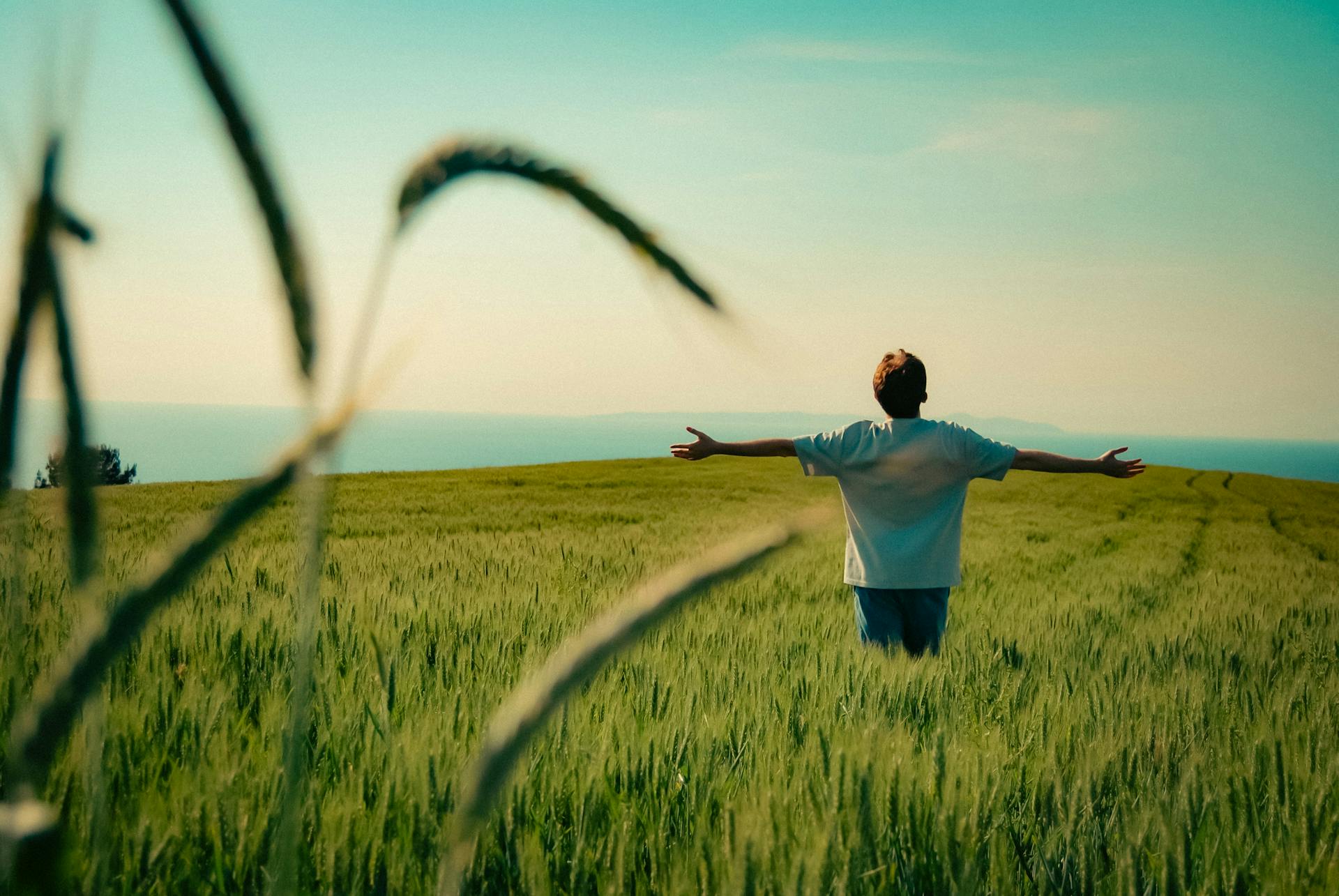 Man Enjoying Nature in Green Field