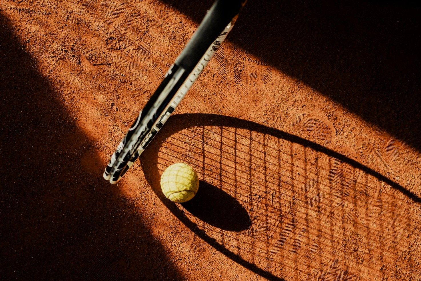 Tennis ball with racket shadow