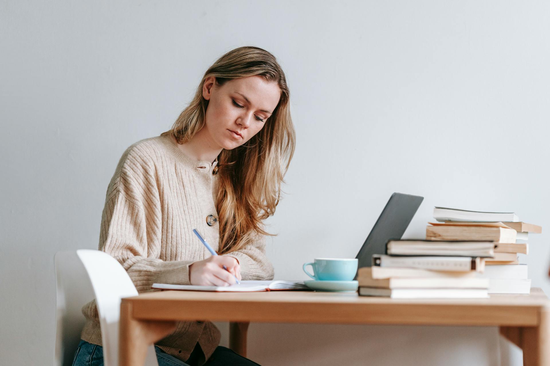 woman writing ideas in notebook