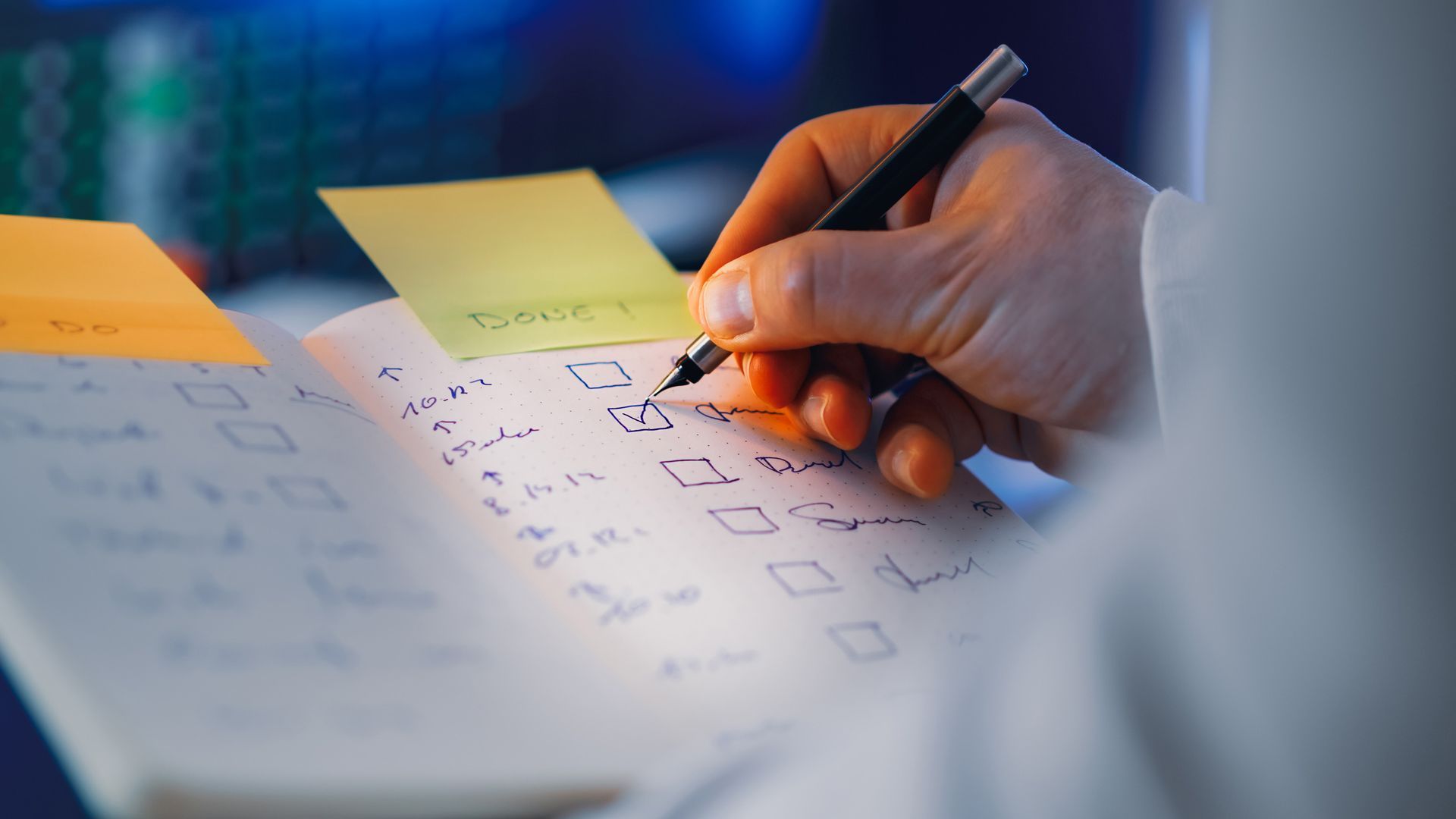 a hand writing in a notebook