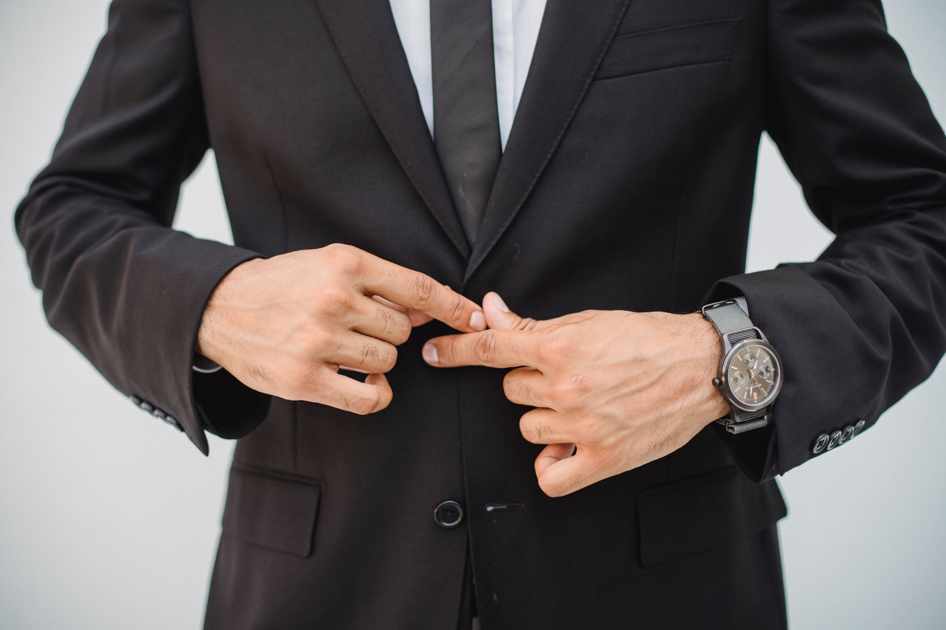 a man adjusting his suit