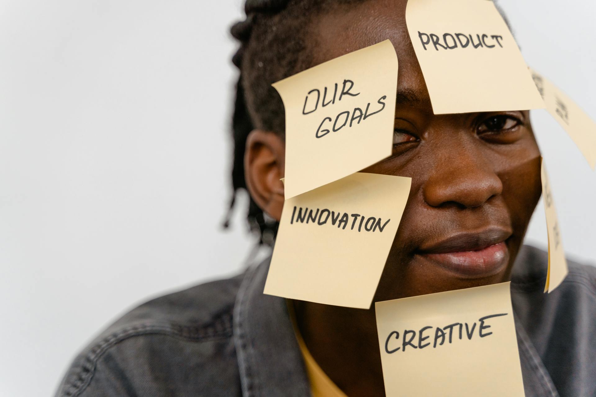A person with sticky notes on face