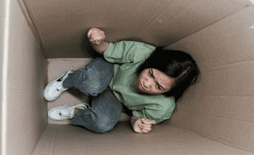 Woman sitting in a box