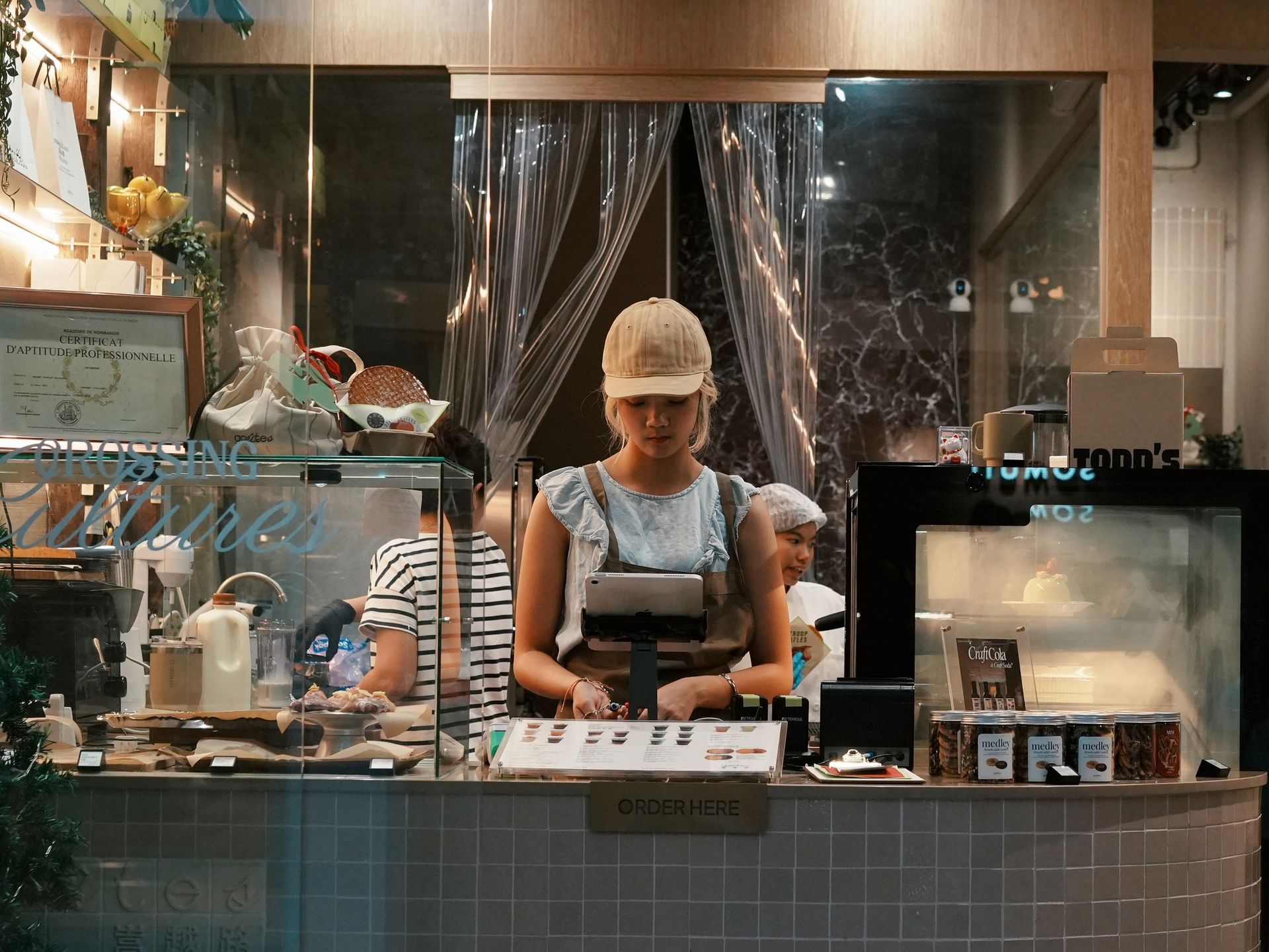 A young woman behind the counter