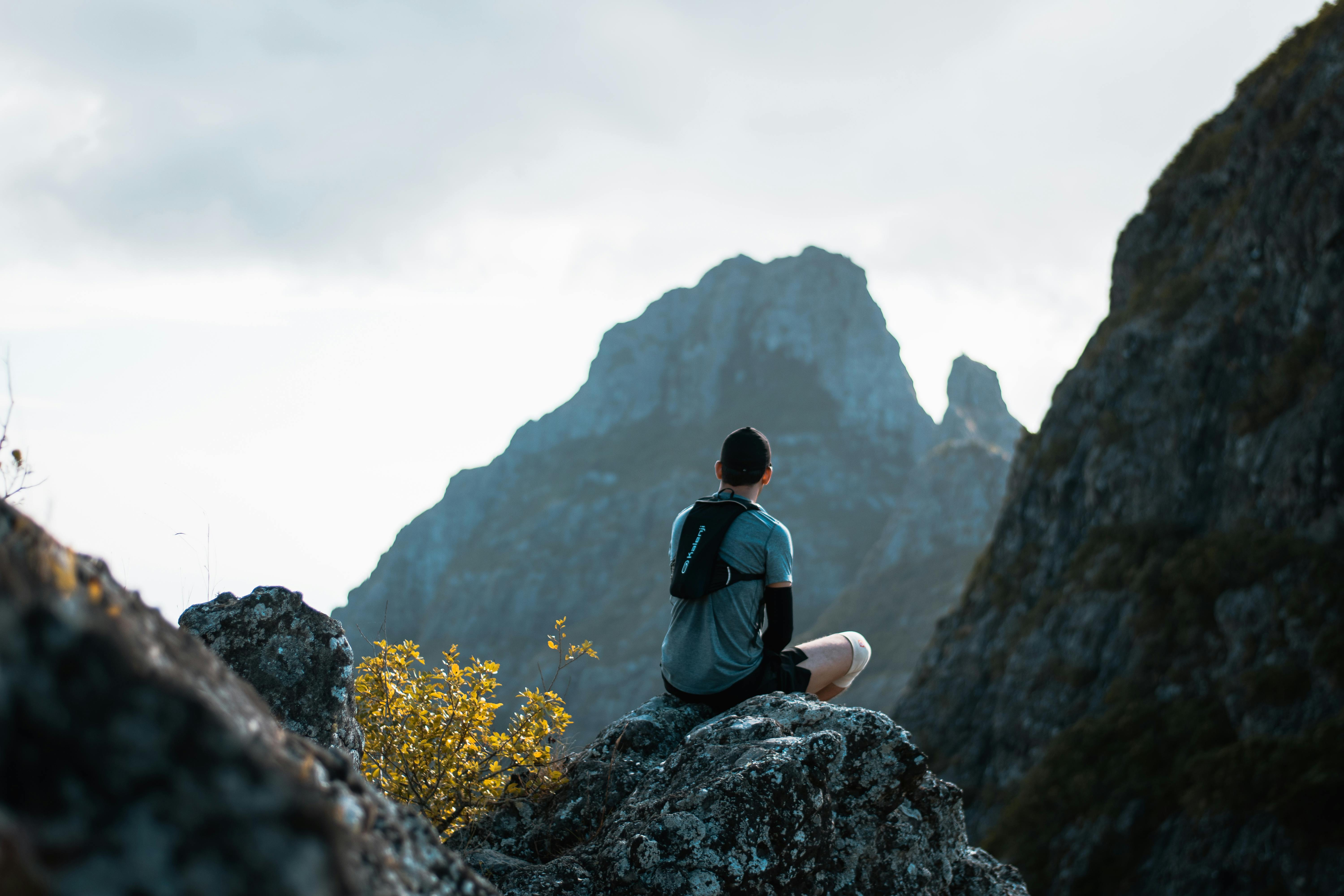 Man Sitting on Rock