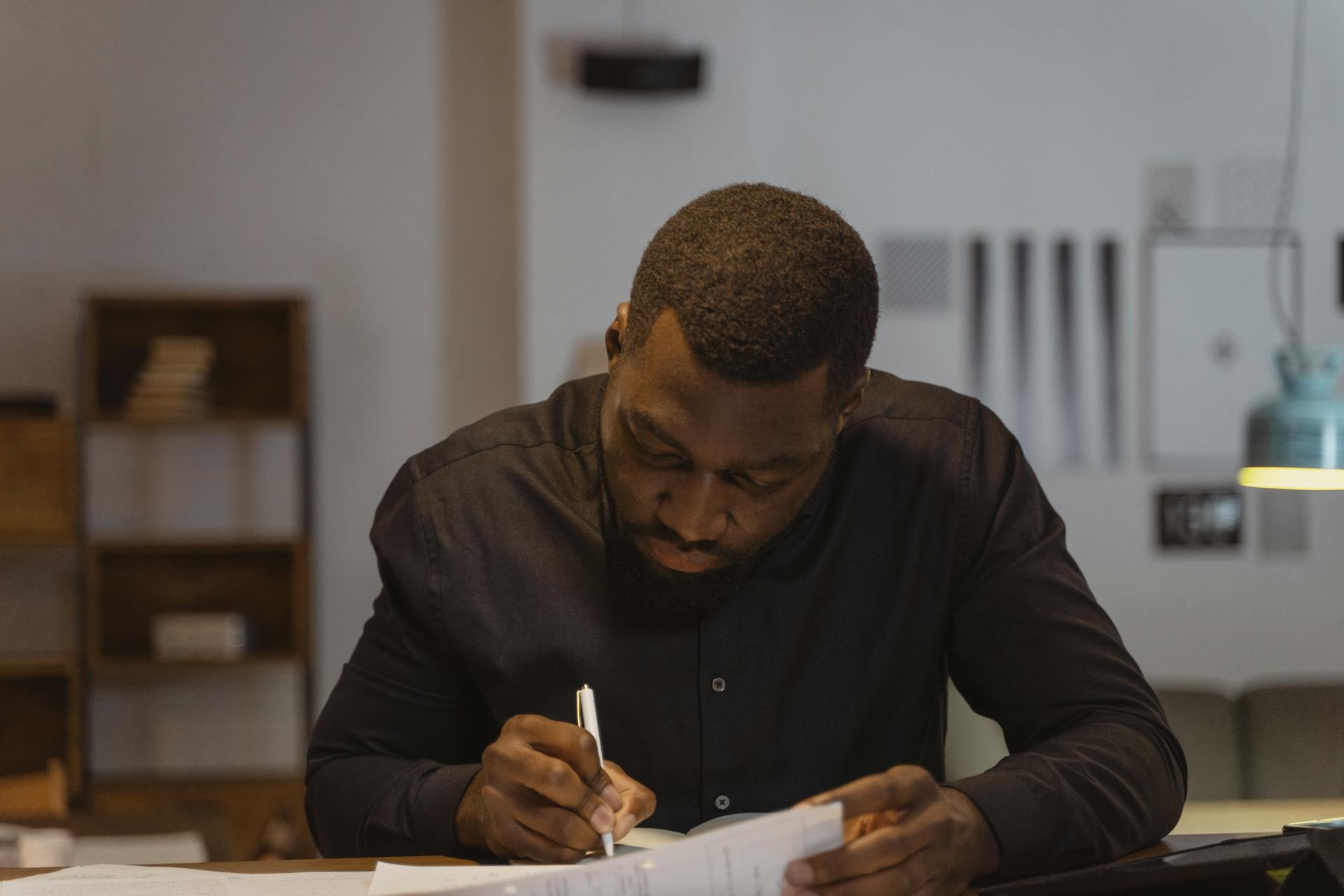 Focused Man writing on Paper