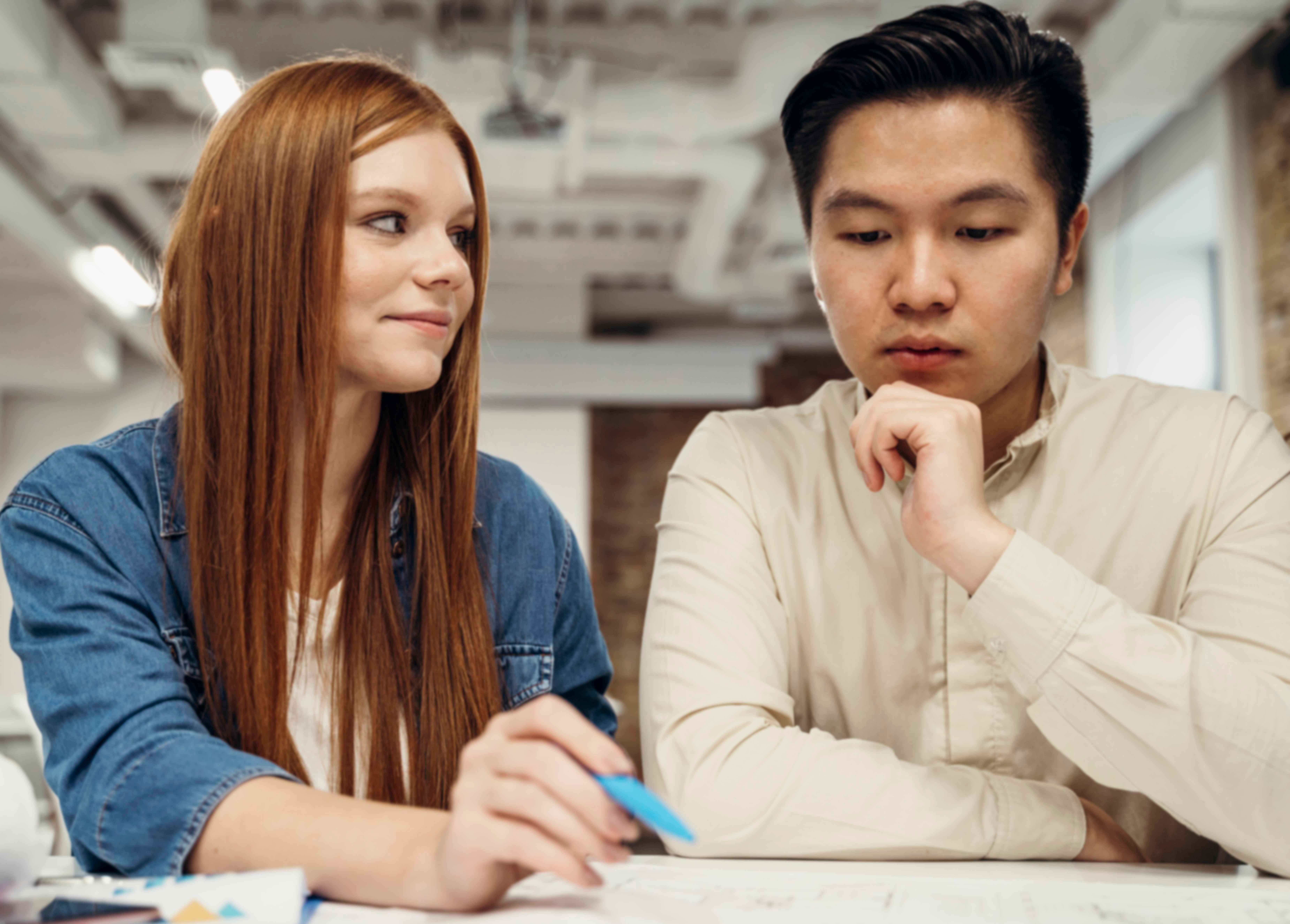 redhead businesswoman discussing with her coworker