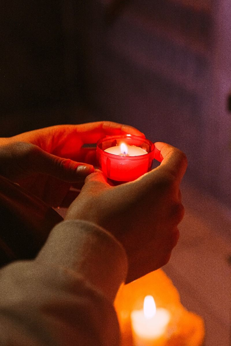 Lighting a candle in prayer is a common ritual in many religions