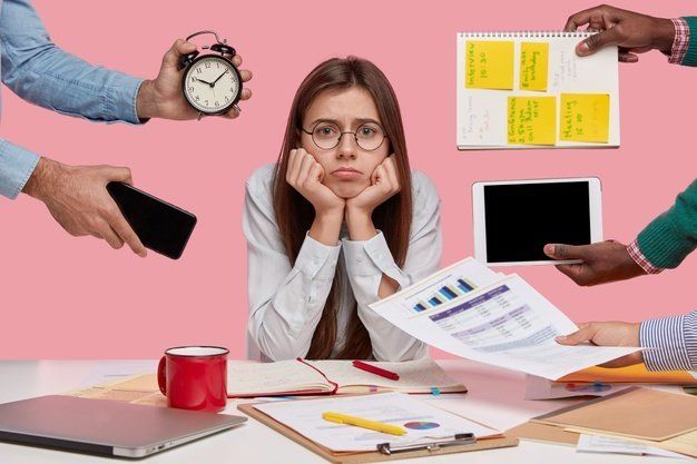 girl surrounded by post-it notes, alarm clock, tablet, signifying busyness