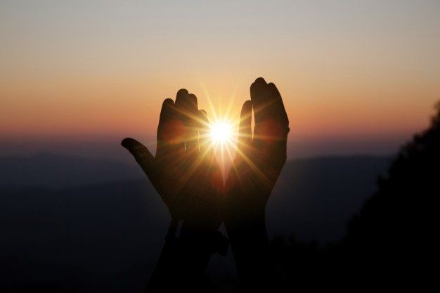 praying and forgiving with sun in hands