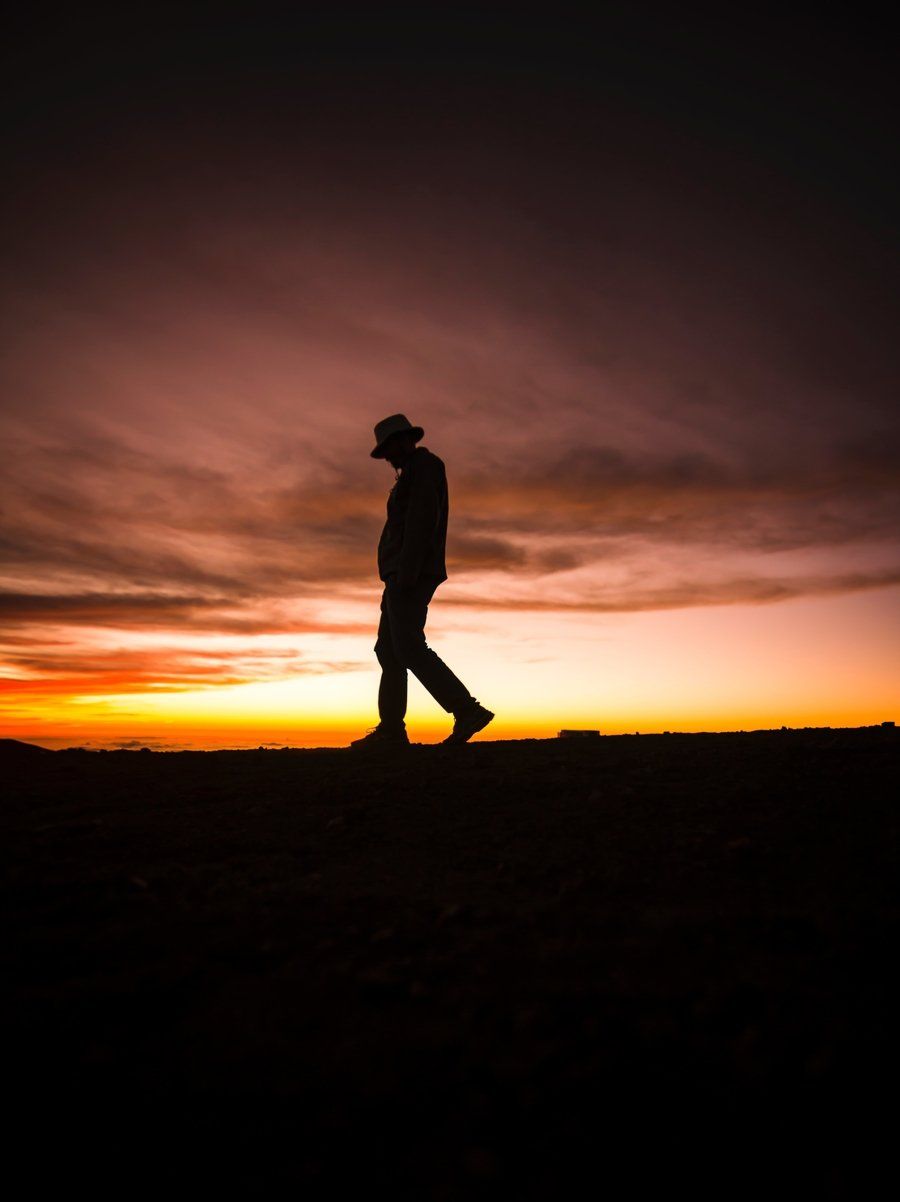 A silhouette of a man walking at sunset (failure)