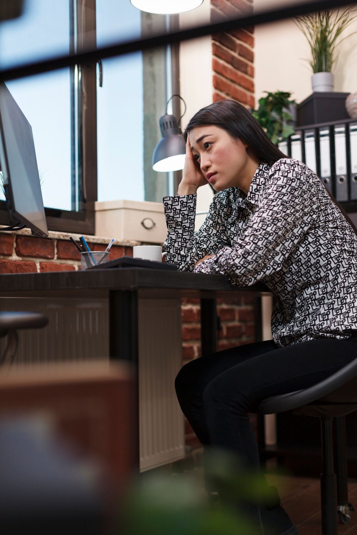 Worried young woman at work looking helpless